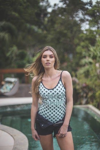 Woman Wearing Green and Black Spaghetti Top