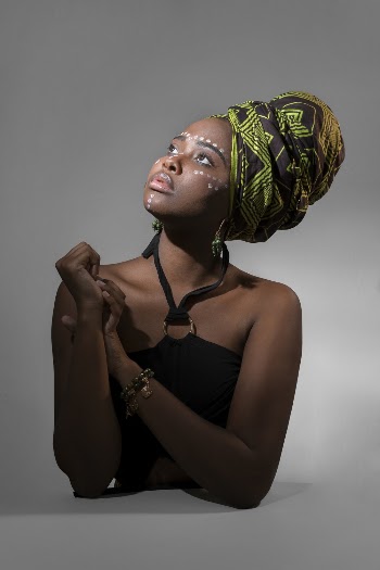 Woman Wearing Green and Brown Turban and Black Halter Dress