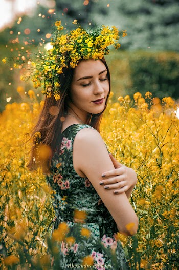 Woman Wearing Green and Pink Floral Sleeveless Dress With Yellow Flower Headdress