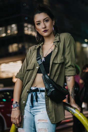 Woman Wearing Green Coat and Black Fanny Bag
