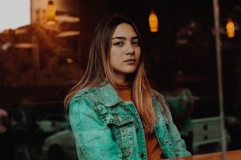 woman wearing green denim jacket