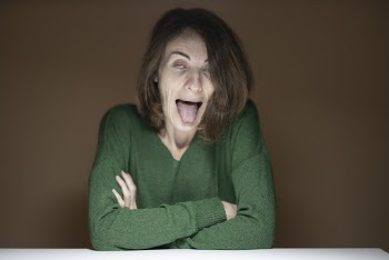 Woman Wearing Green Long Sleeved Shirt Making Face