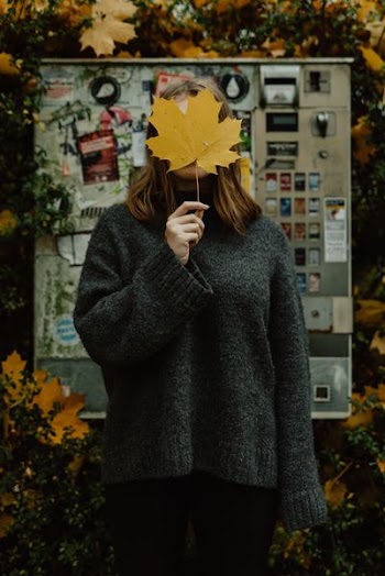 woman wearing green sweater]
