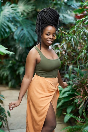 Woman Wearing Green Tank Top Standing Near Green Plants
