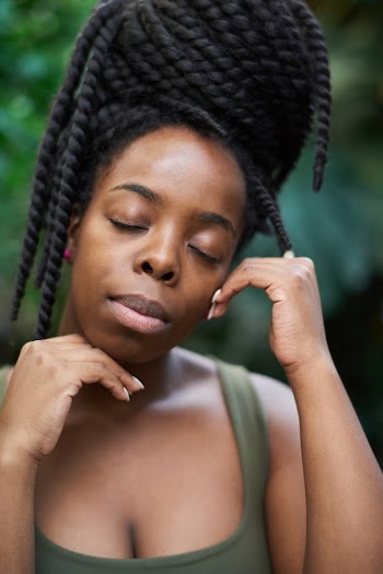 Woman Wearing Green Tank Top While Closing Her Eyes
