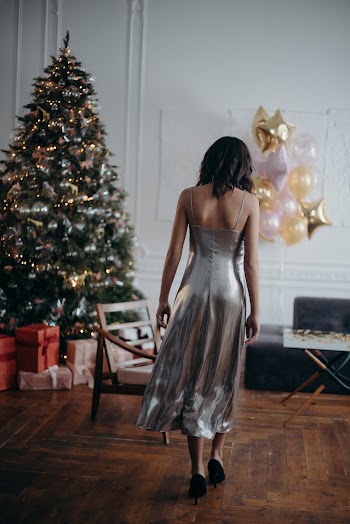 Woman Wearing Grey Dress Standing Near Christmas Tree