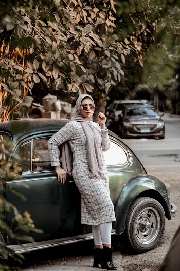 Woman Wearing Grey Long-sleeved Dress Leaning on Black Volkswagen Beetle