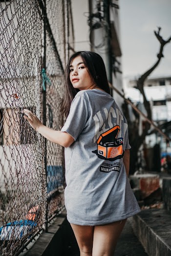 Woman Wearing Grey Shirt Standing Beside Fence