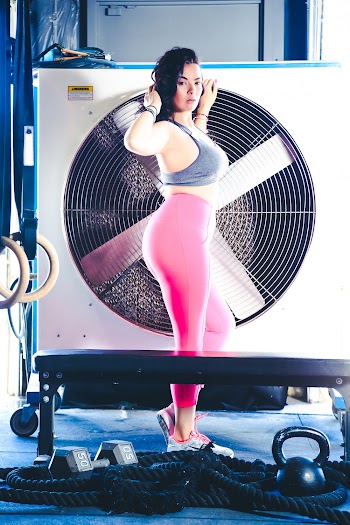 Woman Wearing Grey Sports Bra And Pink Leggings