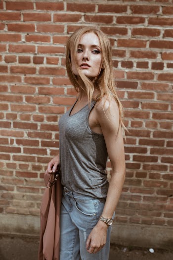 Woman Wearing Grey Tank Top And Denim Jeans
