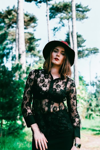 Woman Wearing Hat And Black Lace Blouse