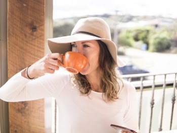 Woman Wearing Hat Holding Mug