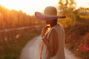 Woman Wearing Hat Standing in the Middle of the Road