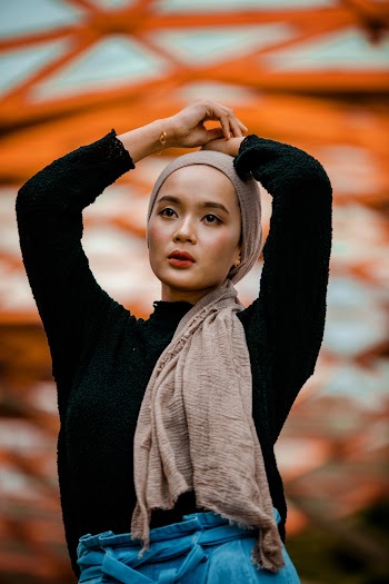 Woman Wearing Headdress and Black Sweater Dancing