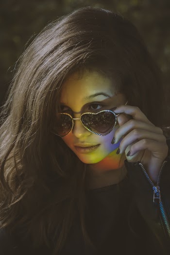 Woman Wearing Heart-Shaped Sunglasses and Black Leather Jacket