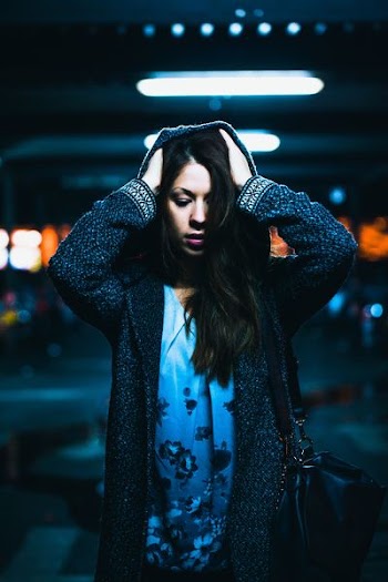 woman wearing hooded cardigan under fluorescent lamp