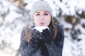 woman wearing jacket and holding snow
