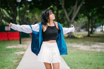 Woman Wearing Jacket, Crop Top and Mini Skirt
