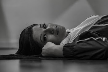 Woman Wearing Jacket Lying on Floor