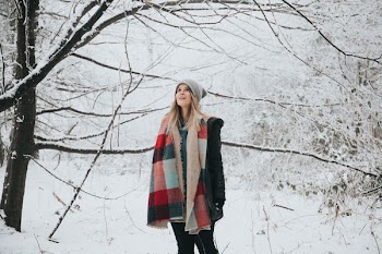 woman wearing jacket outdoor with forest filled with snow