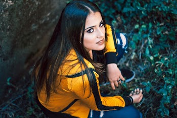 Woman Wearing Jacket Sitting on Grass
