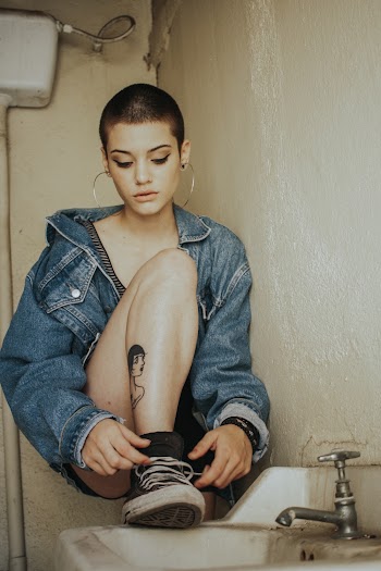 Woman Wearing Jacket Tying Shoe