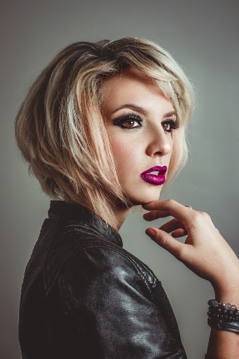 Woman Wearing Leather Jacket Touching Her Jaw