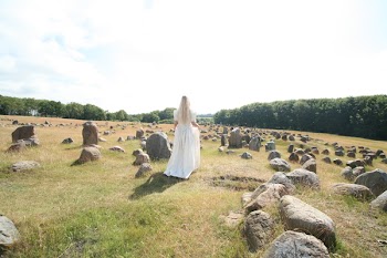 Woman Wearing Long Dress Standing Near Rocks