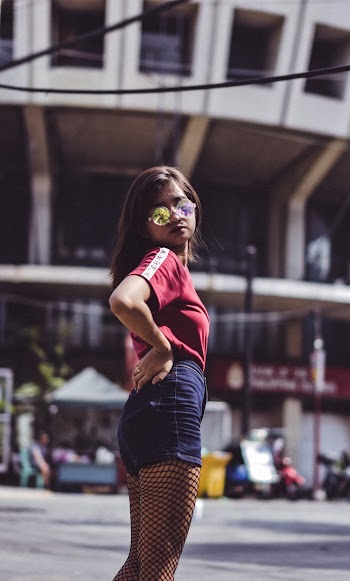 Woman Wearing Maroon Crew-neck Shirt and Blue Denim Short