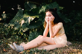Woman Wearing Mini Dress While Sitting on Ground