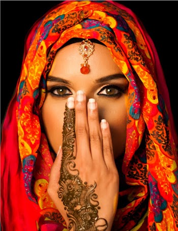 Woman Wearing Multicolored Floral Hijab Covering Her Mouth and Nose with Her Hand