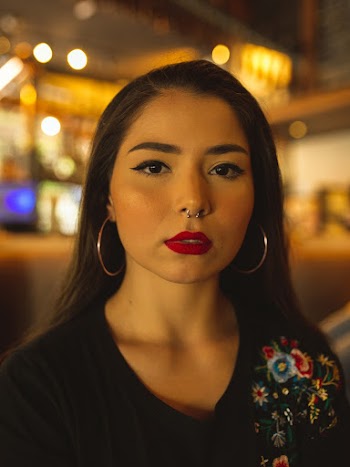 Woman Wearing Nose Ring and Gold Hoop Earrings
