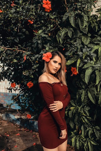 Woman Wearing Off-shoulder Dress Standing Beside Hibiscus Plant