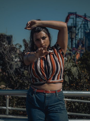 Woman Wearing Orange and Black Stirped Crop Top
