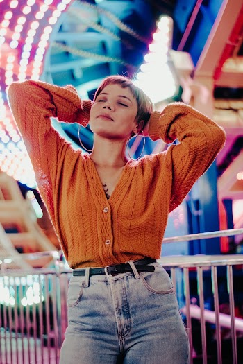 Woman Wearing Orange Button-up Cable Knit Sweater and Denim Bottoms