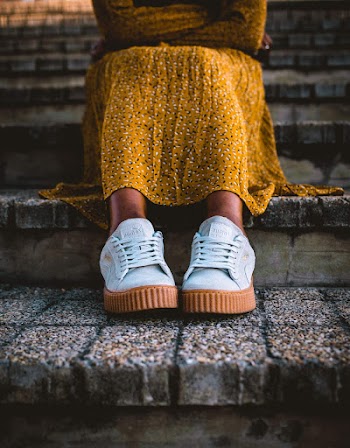 Woman Wearing Orange Long-sleeved Dress and White and Brown Sneakers Sitting