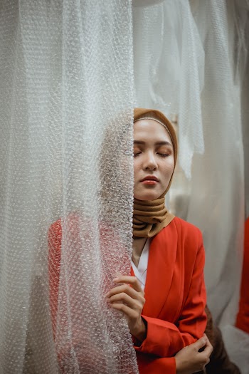 Woman Wearing Orange Long-sleeved Shirt and Brown Hijab