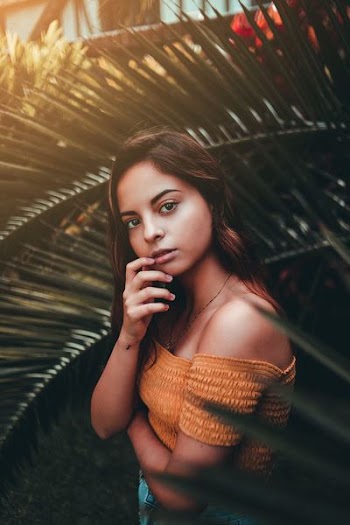 woman wearing orange off-shoulder top