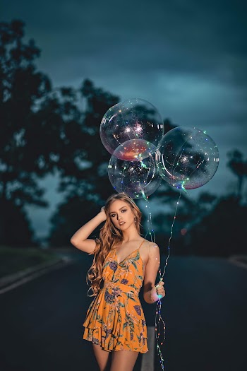 Woman Wearing Orange Spaghetti Strap Dress Holding Three Balloons