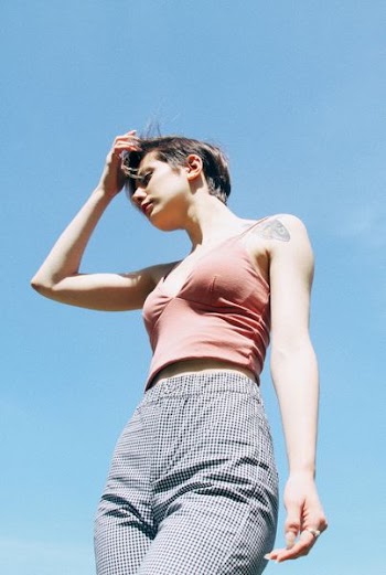 woman wearing orange spaghetti strap top