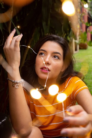 Woman Wearing Orange Top and Looking Upward