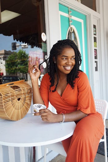 Woman Wearing Orange V-neck Overall Dress Sitting on Chair