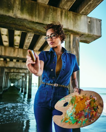 Woman Wearing Over-all Denim Holds A Brush And Palette