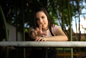 Woman Wearing Pink and Black Top Showing Her Hand