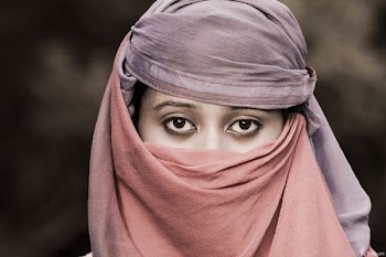 woman wearing pink and purple hijab headdress