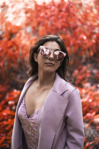 Woman Wearing Pink Blazer and Cat-eye Sunglasses