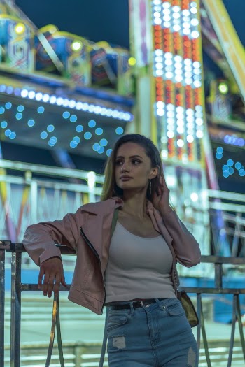 Woman Wearing Pink Cardigan Leaning on Railing