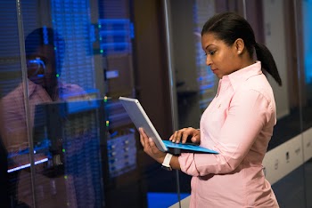 Woman Wearing Pink Dress Shirt Holding Gray Laptop Computer