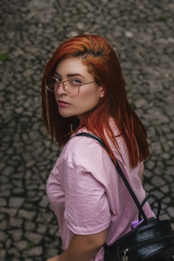 Woman Wearing Pink Shirt Carrying Black Backpack
