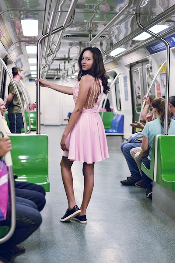 Woman Wearing Pink Sleeveless Dress Inside the Train